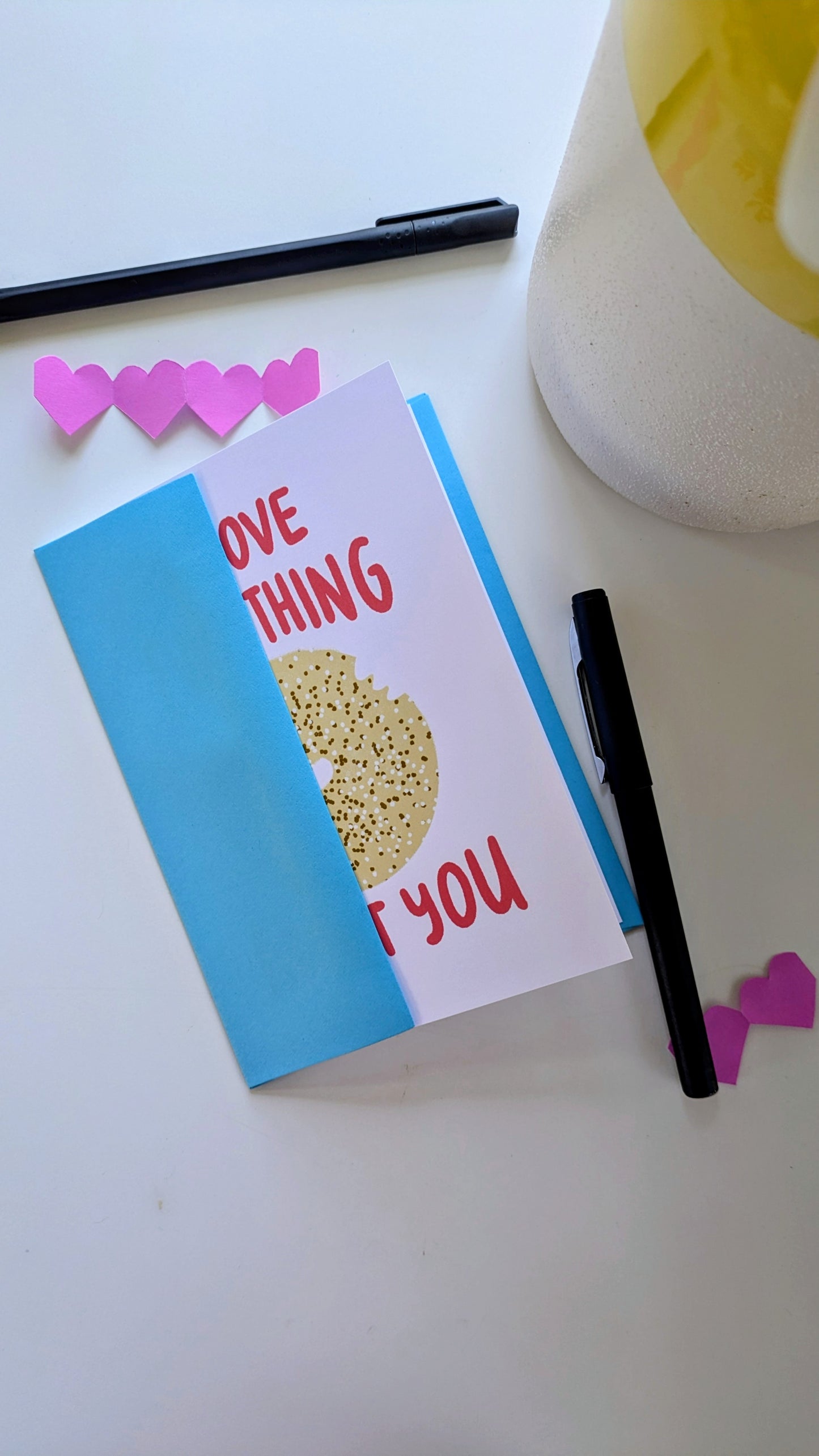 Illustrated greeting card featuring an everything bagel with the message "I love everything about you," including envelope