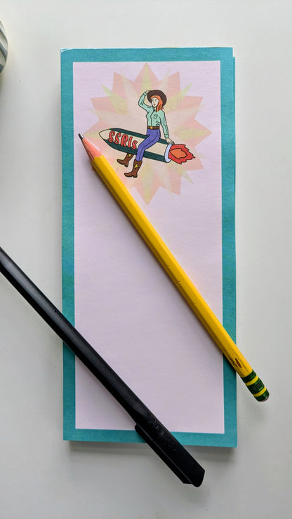 Notebook with a colorful illustration, a yellow pencil, and a black pen on a white background