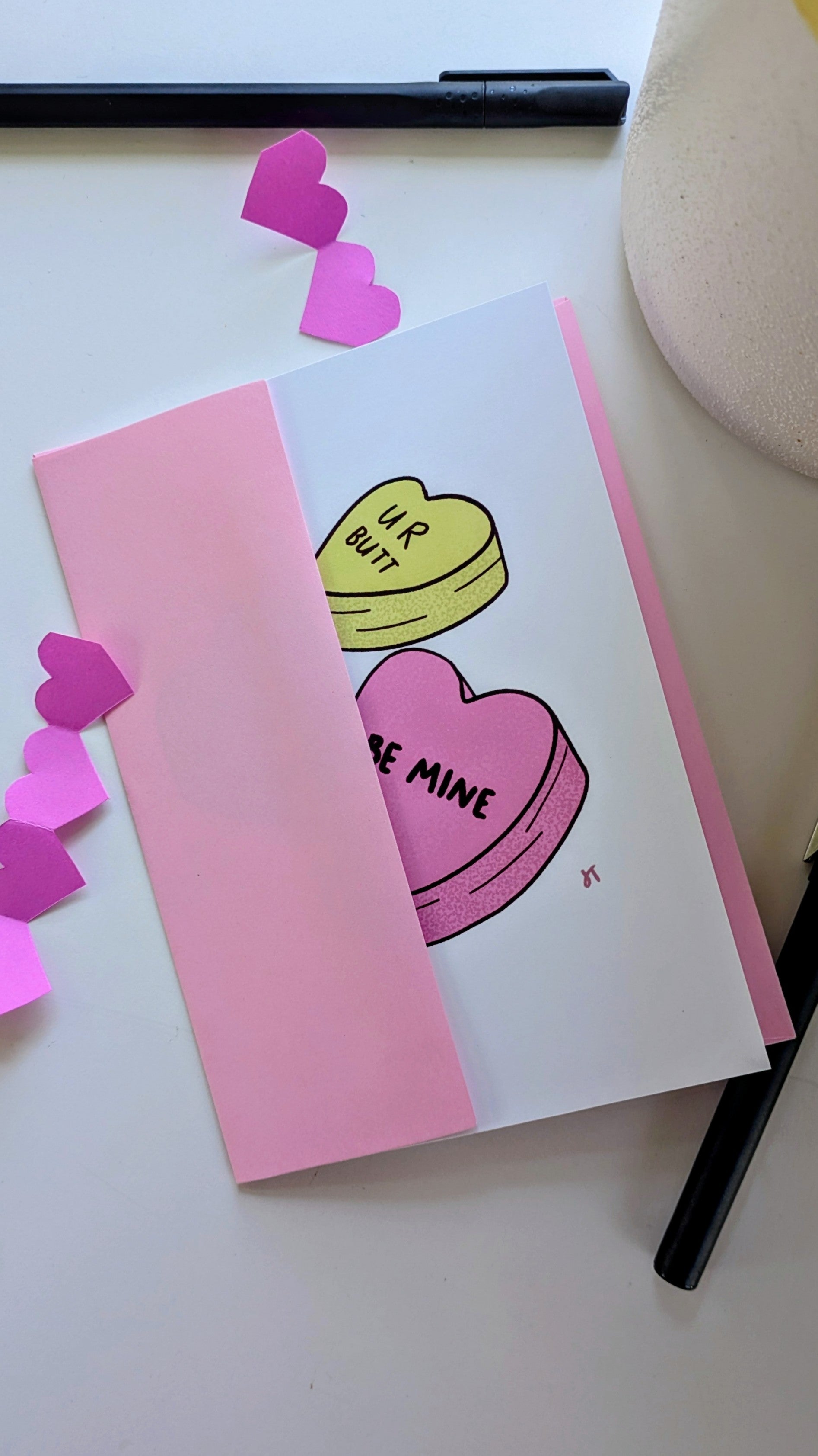 Valentine's Day illustrated greeting card with colorful candy hearts featuring playful love messages and included envelope